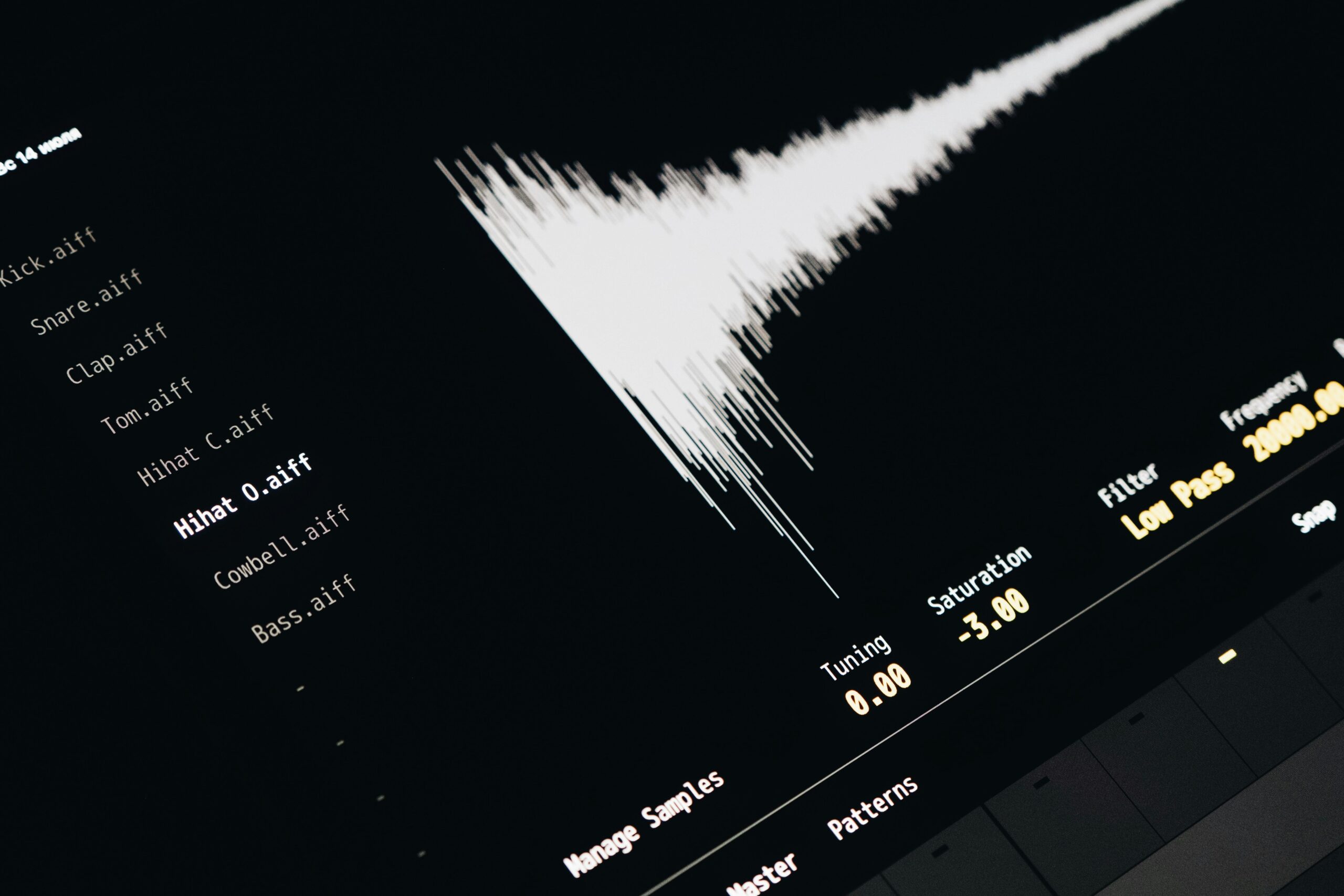 Home Close-up of a digital audio editing interface displaying sound waves and file names.
